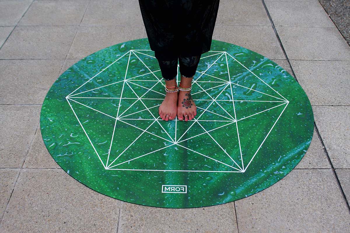 united kingdom person standing on round green Form mat darts
